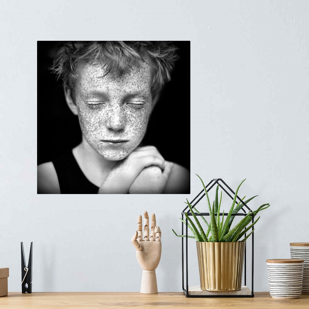 A bohemian room featuring Black and white portrait of a young boy with freckles.