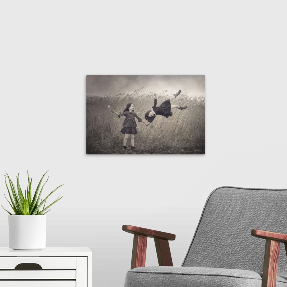 A modern room featuring Conceptual image of two little girls appearing to be blown away in the wind.