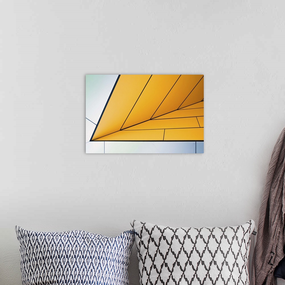 A bohemian room featuring Yellow and white panels on an angular wall creating an abstract image.