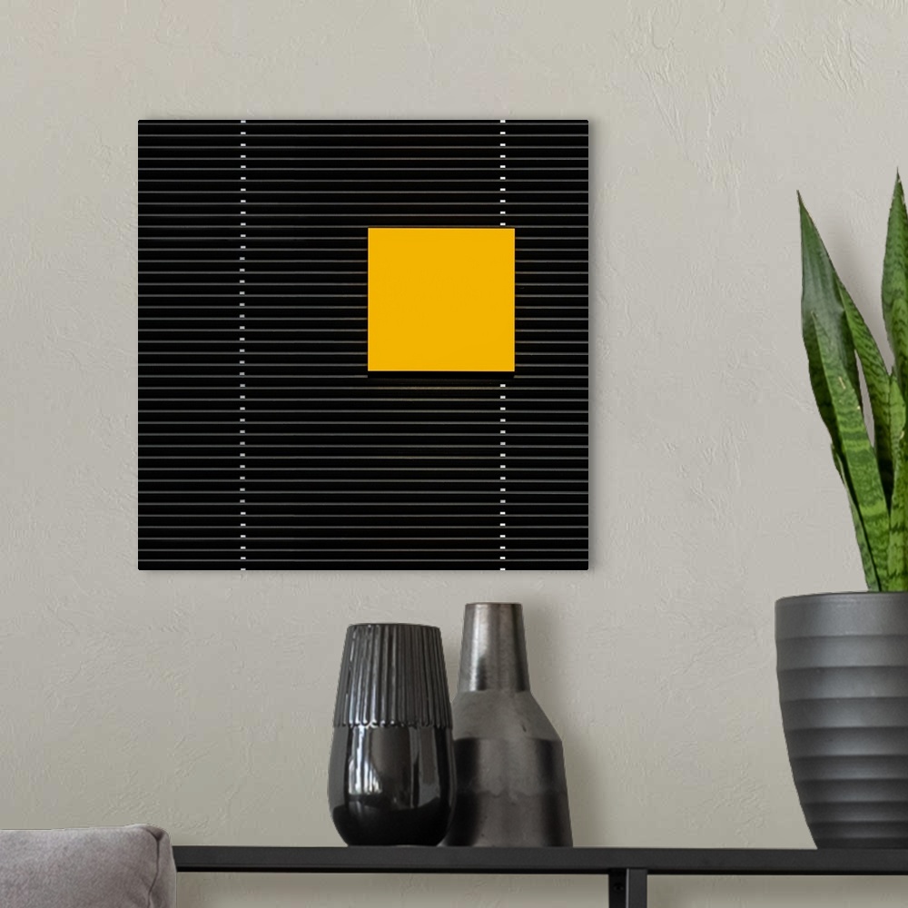 A modern room featuring A yellow square panel standing out against the horizontal lines of a building.