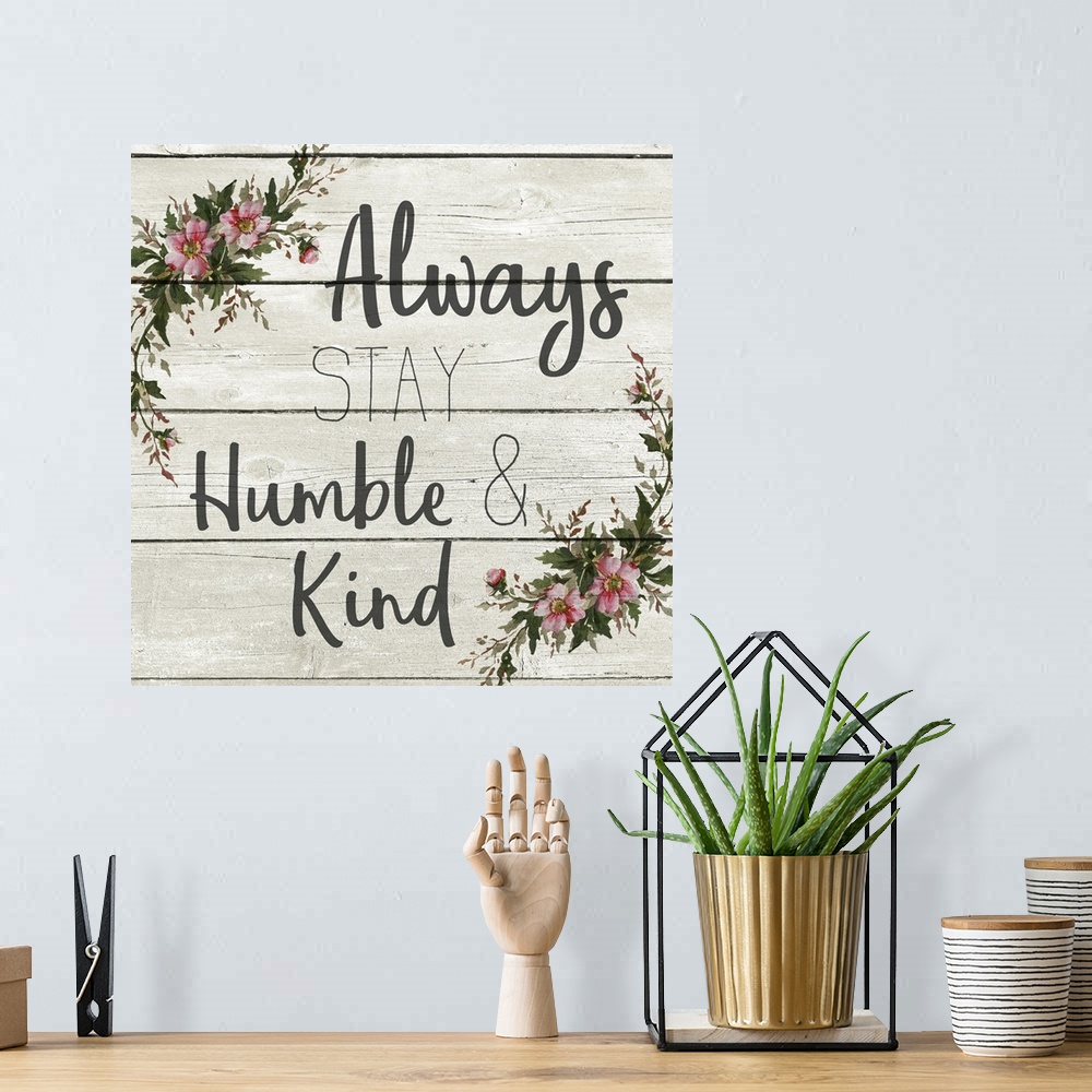 A bohemian room featuring "Always Stay Humble and Kind" with a wreath of flowers on a gray wood plank background.