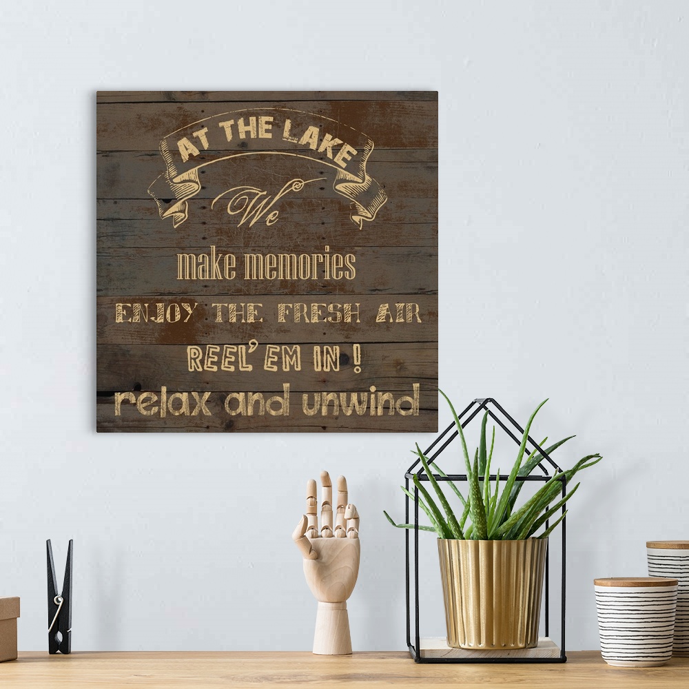 A bohemian room featuring "At the Lake We Make Memories Enjoy the Fresh Air Reel 'em in! Relax and Unwind" on an aged wood ...