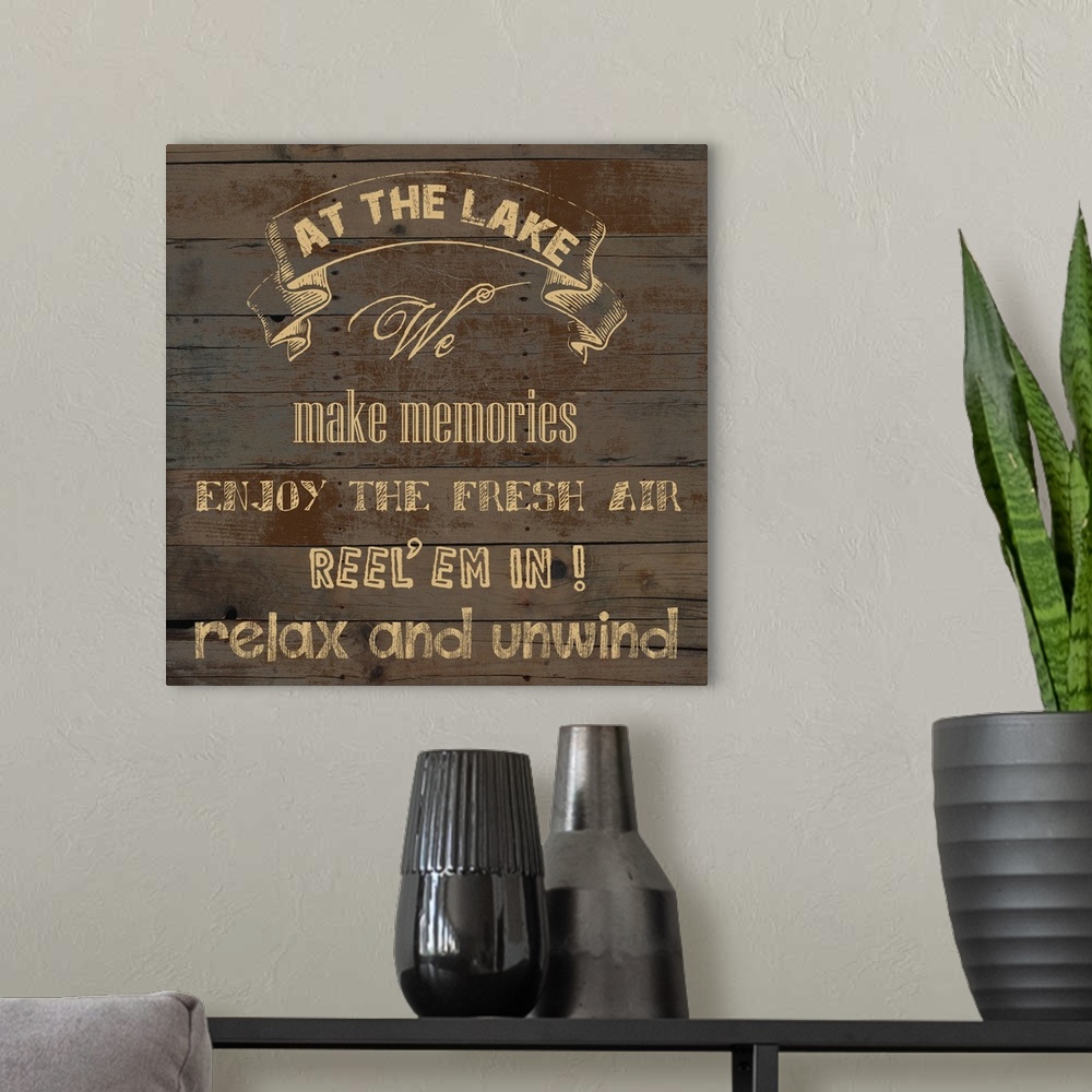 A modern room featuring "At the Lake We Make Memories Enjoy the Fresh Air Reel 'em in! Relax and Unwind" on an aged wood ...