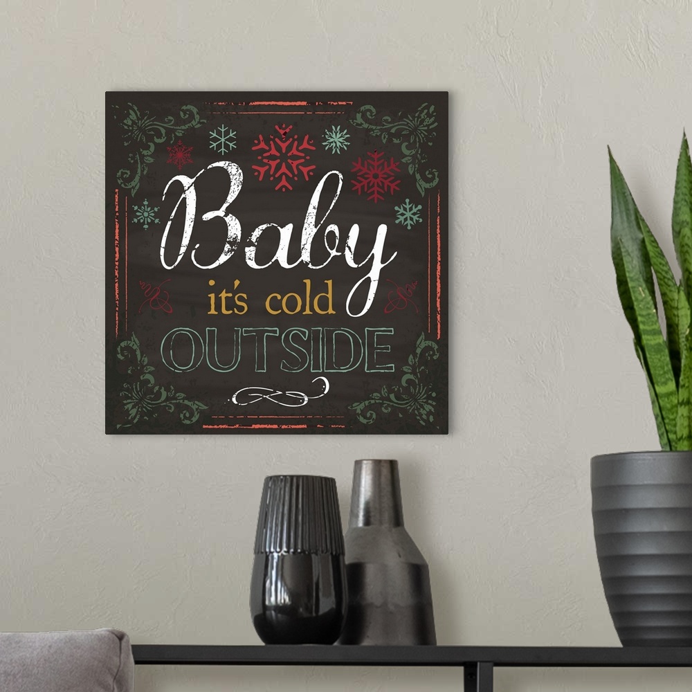 A modern room featuring Chalkboard style art featuring Christmas song lyrics and snowflakes.