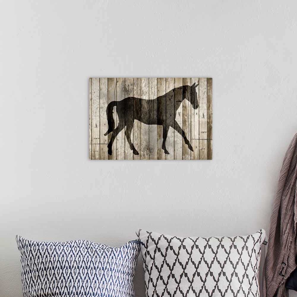 A bohemian room featuring A silhouette of a horse on a rustic wood paneled background.