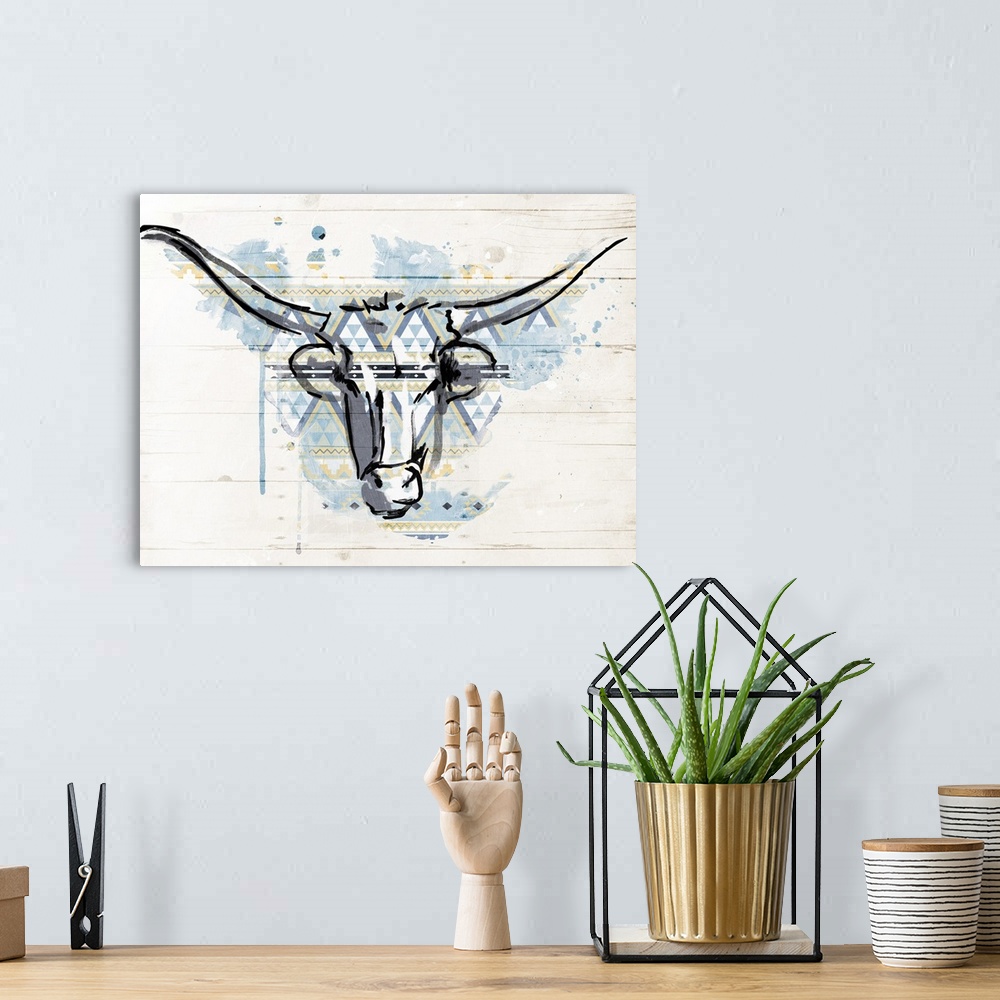 A bohemian room featuring A black outline of a bull?s head with a blue and yellow paint splatter and geometric shaped patte...