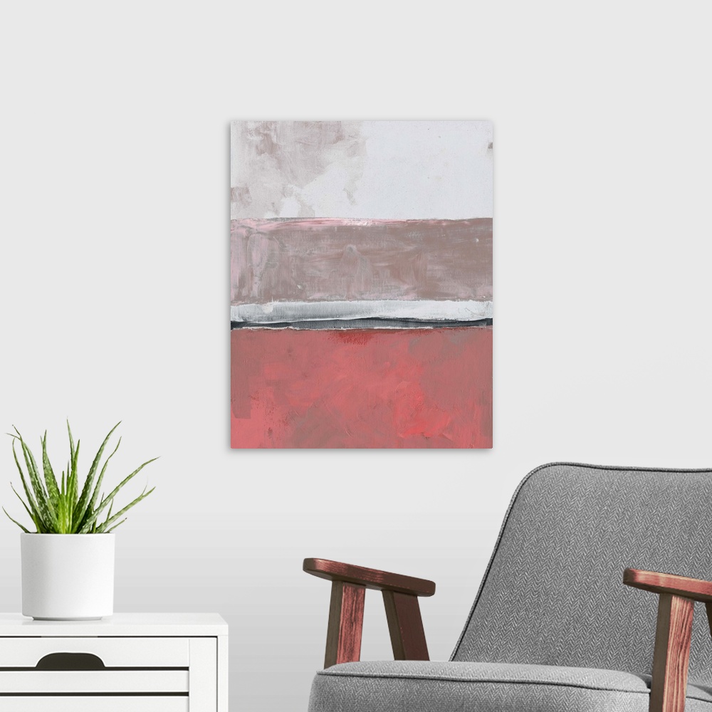A modern room featuring Abstract color block artwork in shades of coral pink and pale grey.