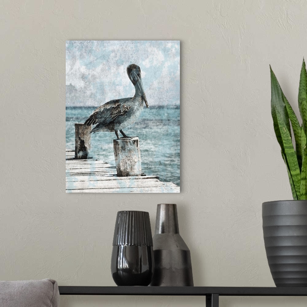 A modern room featuring Black and white photograph of a pelican standing on a dock with light blue tones painted on top.