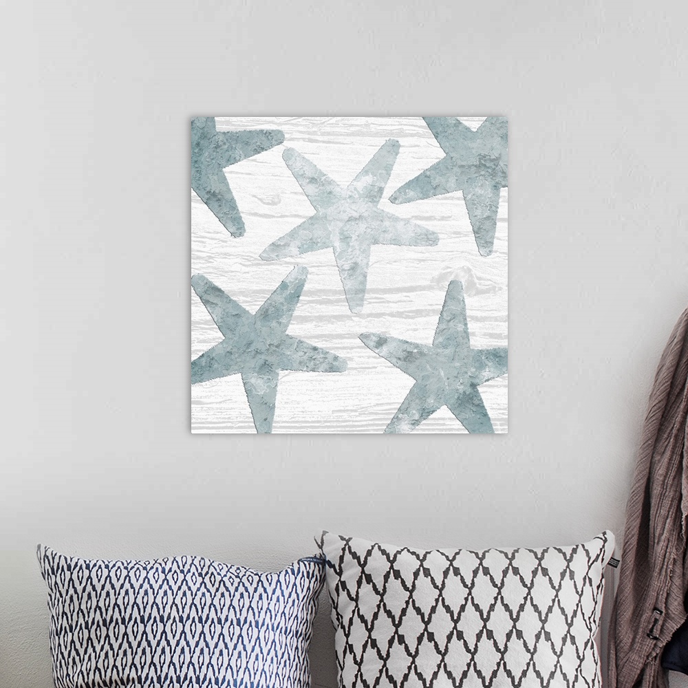 A bohemian room featuring Square watercolor painting of blue starfish on a white wood grain background.