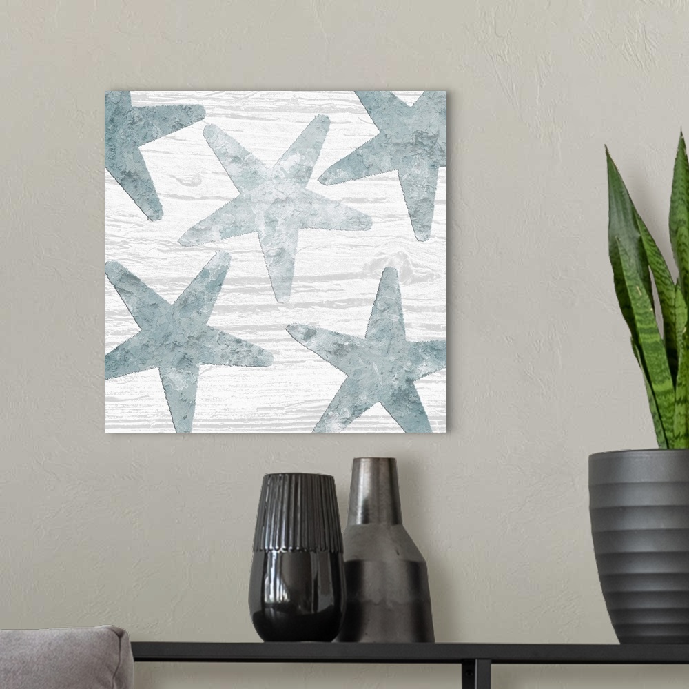 A modern room featuring Square watercolor painting of blue starfish on a white wood grain background.