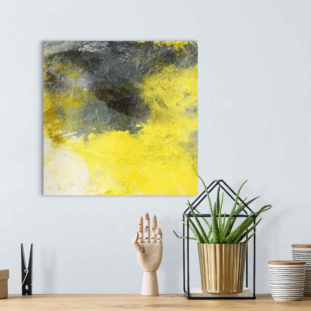 A bohemian room featuring Bright yellow and dark gray merging together in this abstract painting.