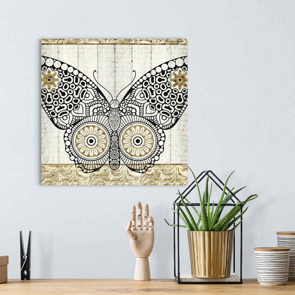 A bohemian room featuring A black and gold symmetrically designed butterfly on a white wood panel background with faint han...