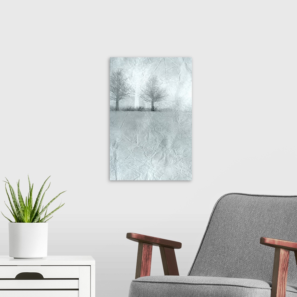 A modern room featuring Landscape painting of a misty field with bare trees on the horizon.