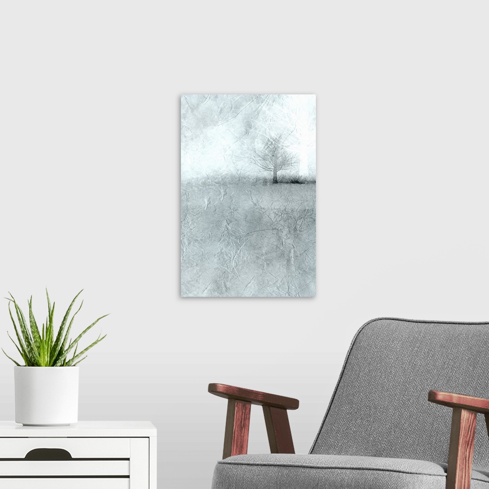A modern room featuring Landscape painting of a misty field with bare trees on the horizon.