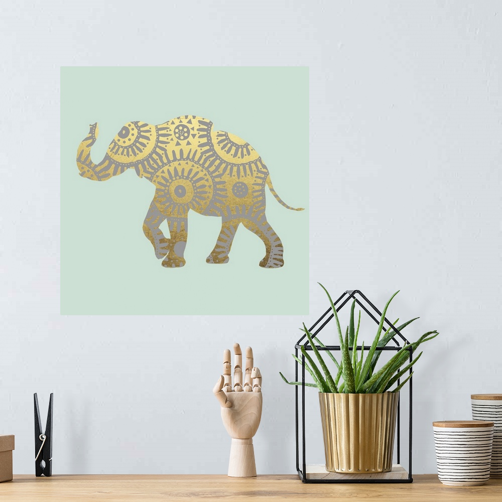 A bohemian room featuring Square illustration of a metallic gold elephant with silver designs on a light green background.