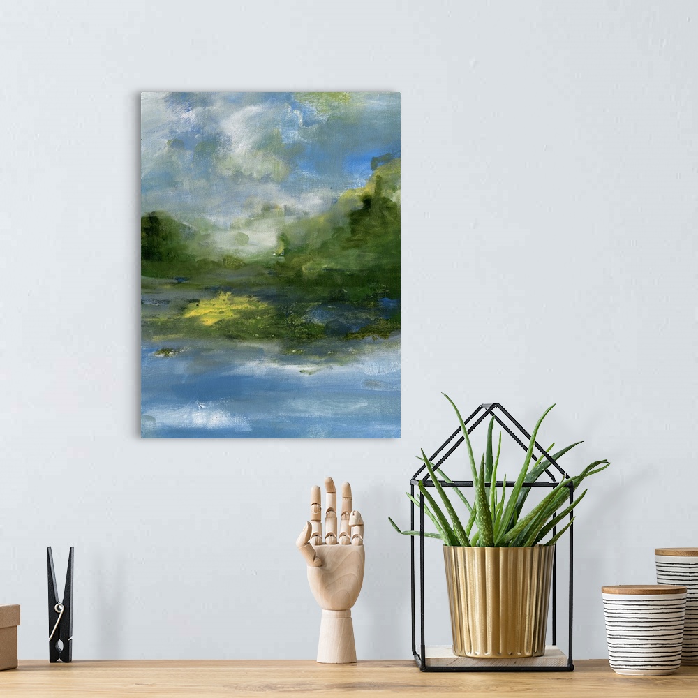 A bohemian room featuring Contemporary landscape painting of a lake with verdant hills and a cloudy sky.