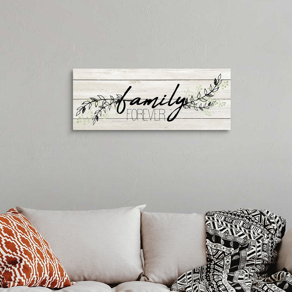 A bohemian room featuring "Family Forever" with a branches of leaves on a white wood plank background.