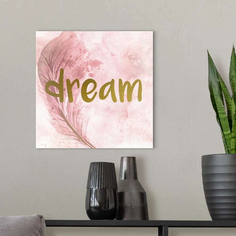 A modern room featuring A pink watercolor painting of a feather with the word ?dream? placed on top in gold text.�