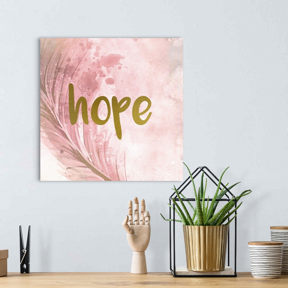 A bohemian room featuring A pink watercolor painting of a feather with the word ?hope? placed on top in gold text.�