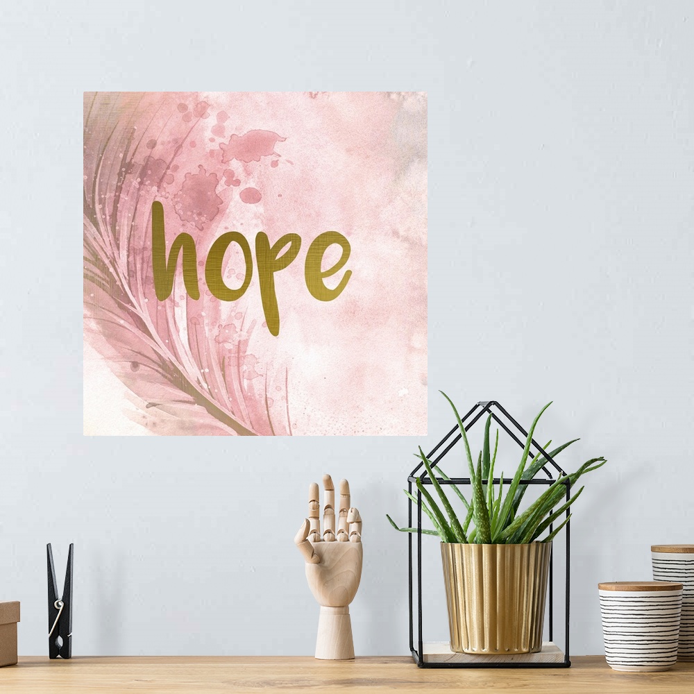 A bohemian room featuring A pink watercolor painting of a feather with the word ?hope? placed on top in gold text.�