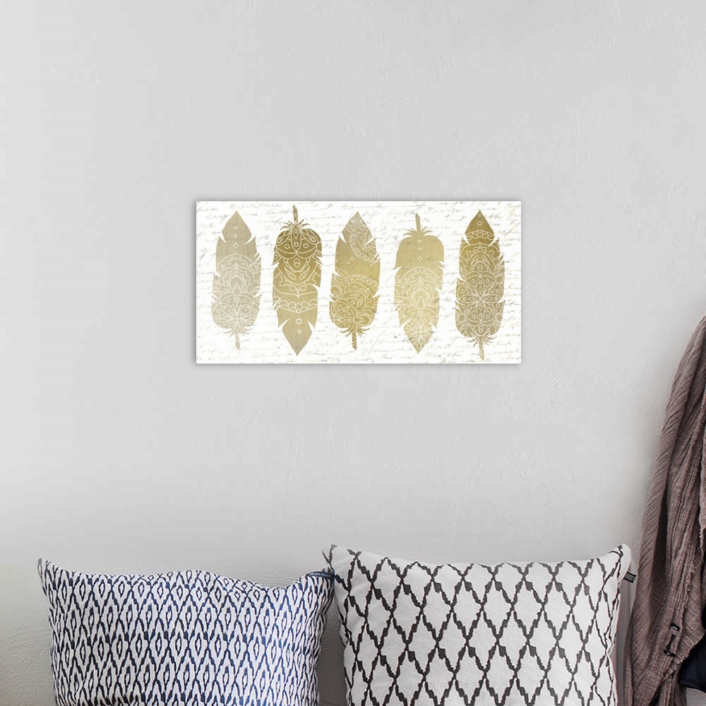 A bohemian room featuring A row of five golden feathers with white Bohemian patterns.