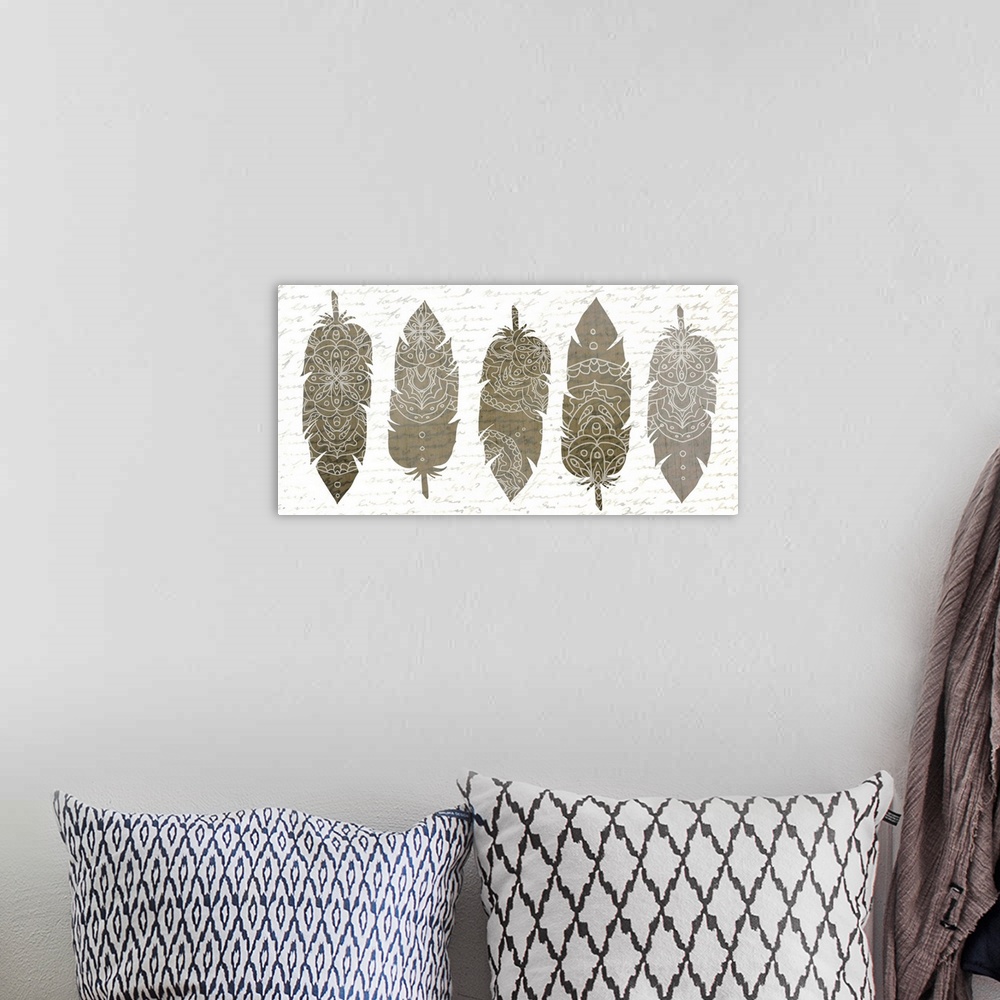 A bohemian room featuring A row of five silver feathers with white Bohemian patterns.