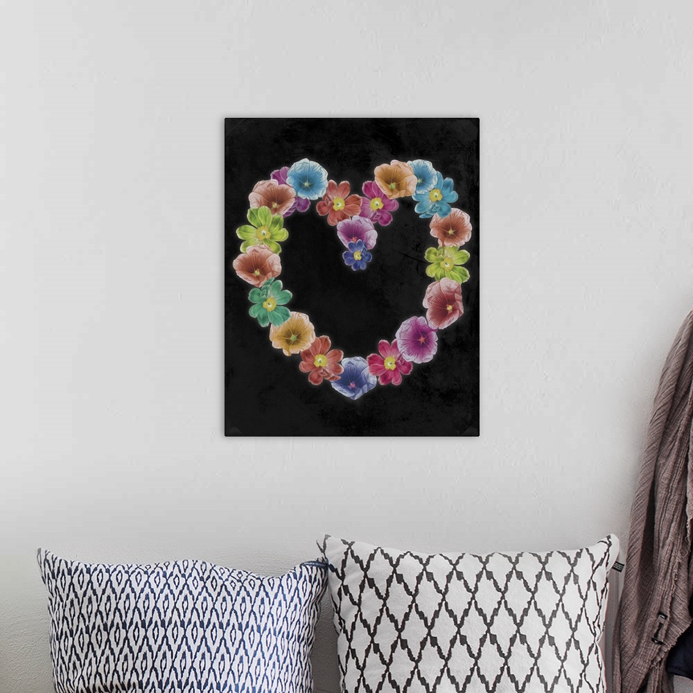 A bohemian room featuring Artwork of wreath in the shape of a heart made of tropical flowers, against a black background.