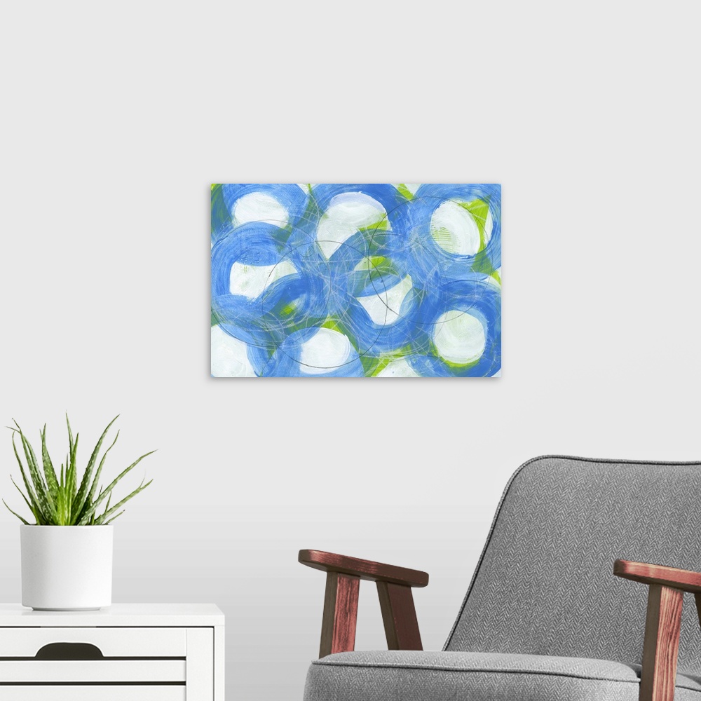 A modern room featuring Contemporary abstract artwork made of several large rings in blue tones.