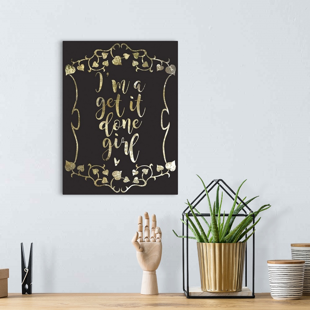 A bohemian room featuring "I'm a get it done girl" written in a gold sparkle font on a black background.