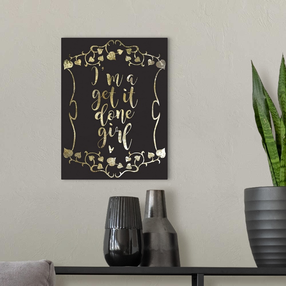 A modern room featuring "I'm a get it done girl" written in a gold sparkle font on a black background.