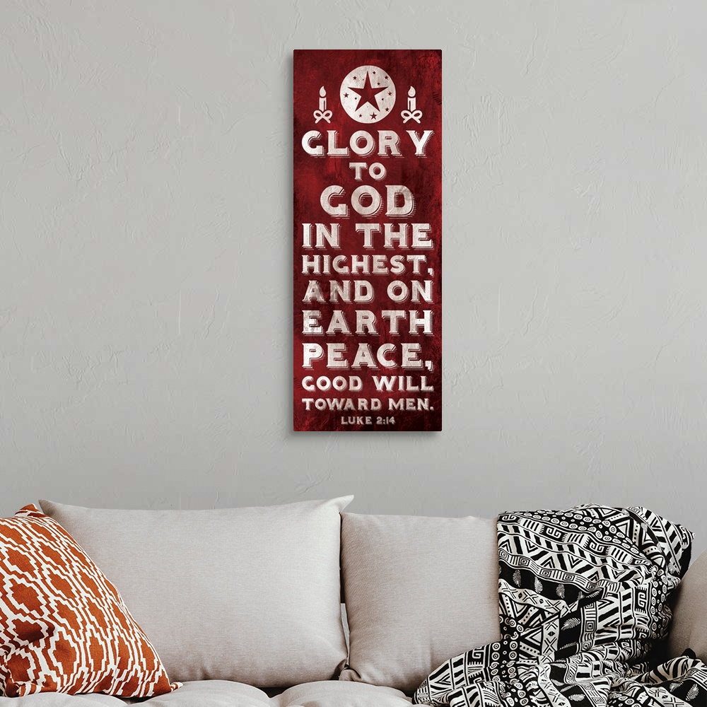 A bohemian room featuring Vertical Christmas themed typography art of the Bible verse Luke 2:14 in white text on red.