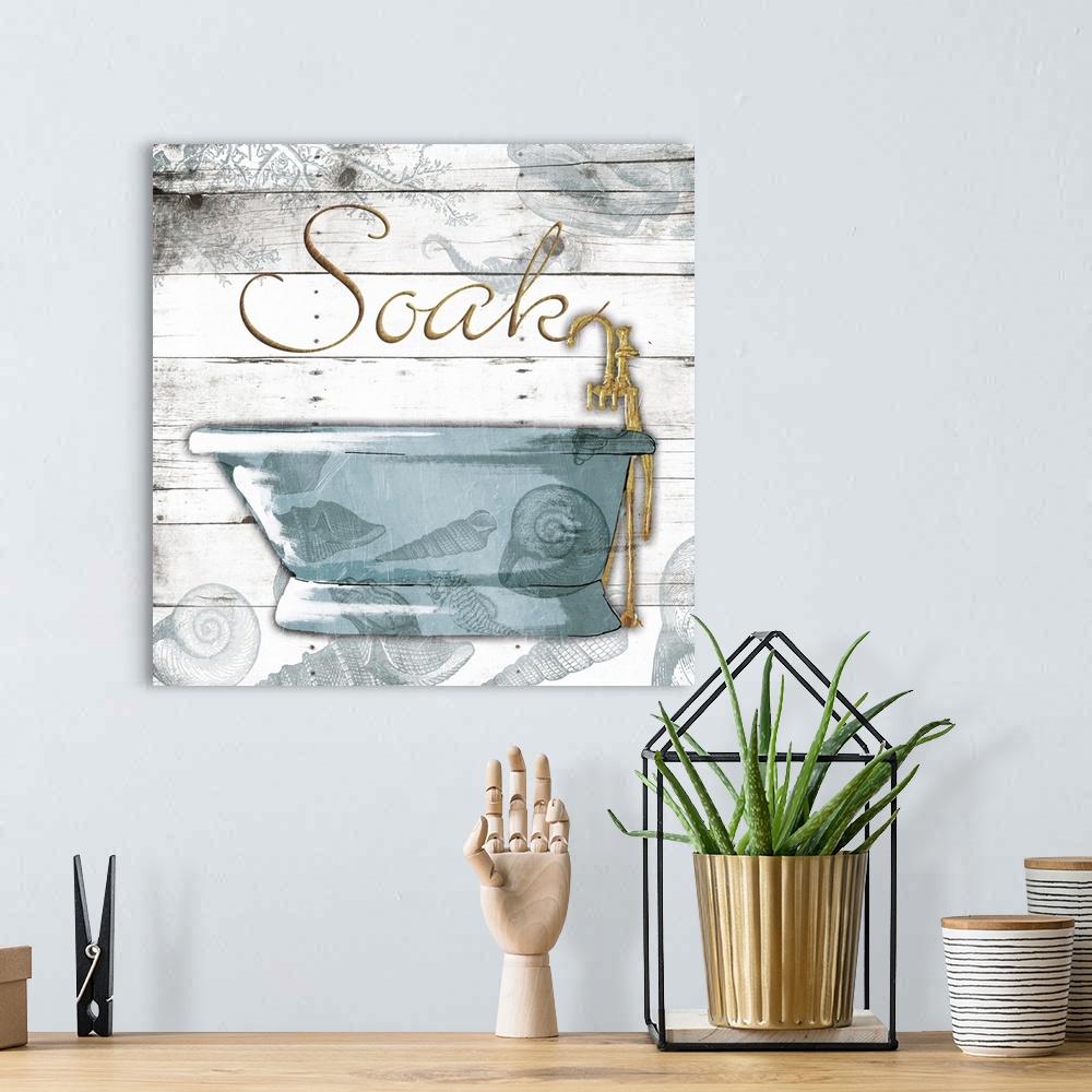 A bohemian room featuring ?Soak? painted in gold with a blue bath tub on a white wood panel background with a seashell over...