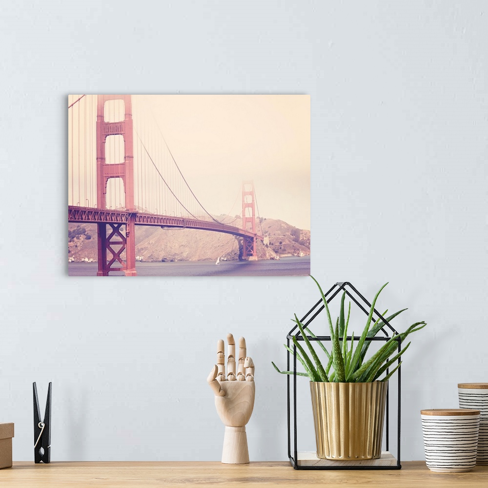 A bohemian room featuring Artistically filtered photograph of the golden gate bridge shrouded in heavy fog.