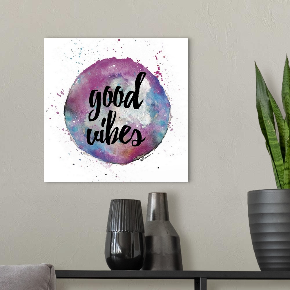 A modern room featuring A watercolor sphere in pink and blue shades with hand-lettered text inside.