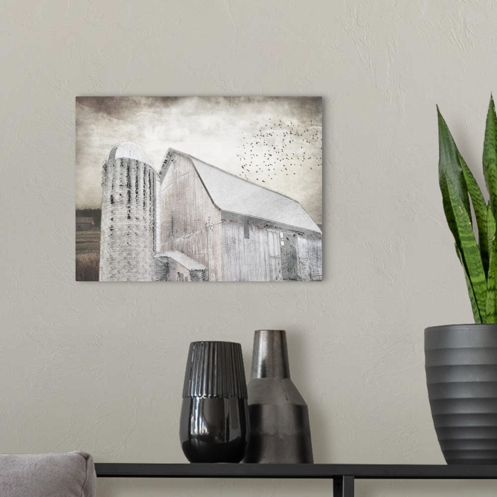 A modern room featuring An image in shades of gray of a barn with a flock of birds above with a textured overlay.