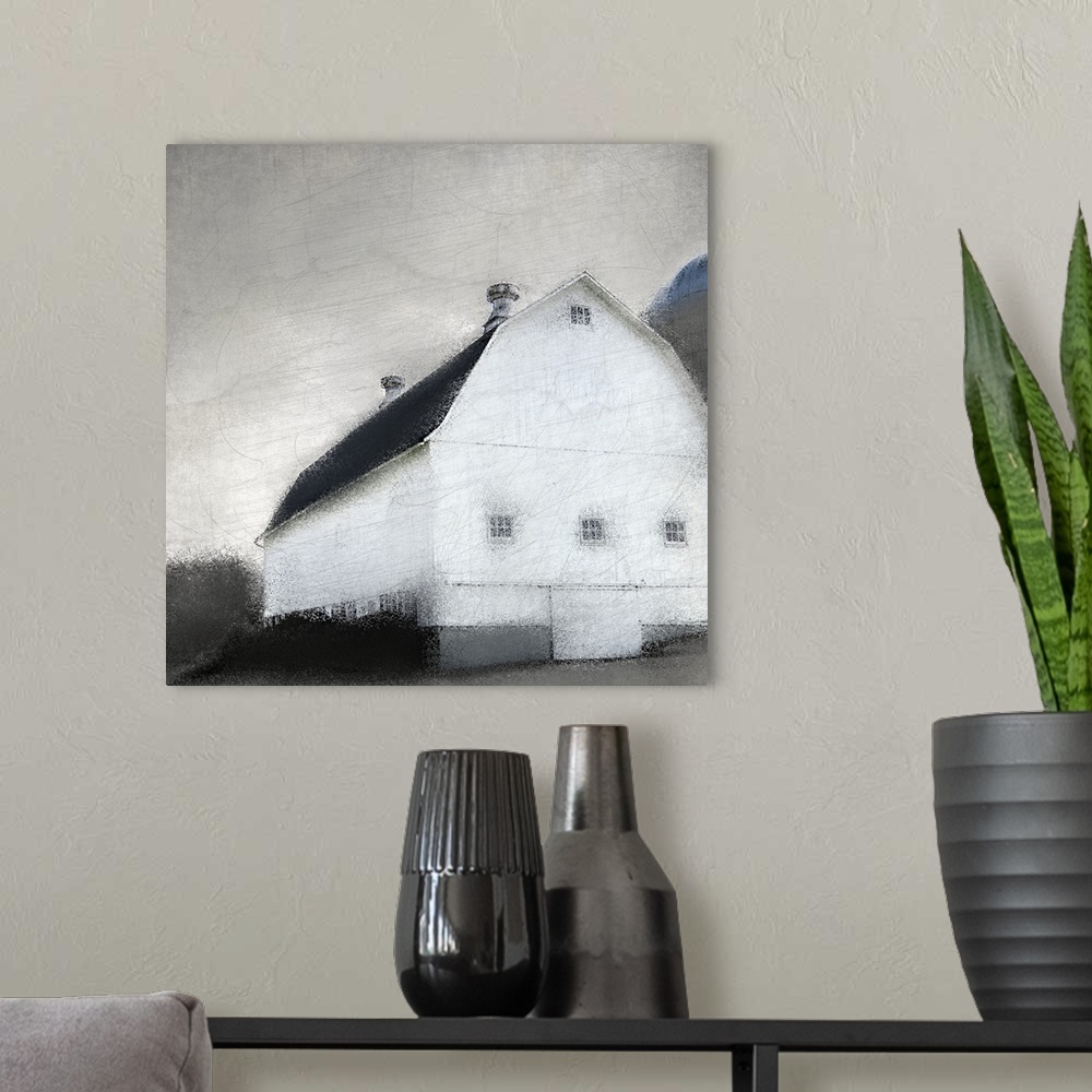 A modern room featuring An image in shades of gray of a barn with trees behind it and a gray sky with a textured overlay.