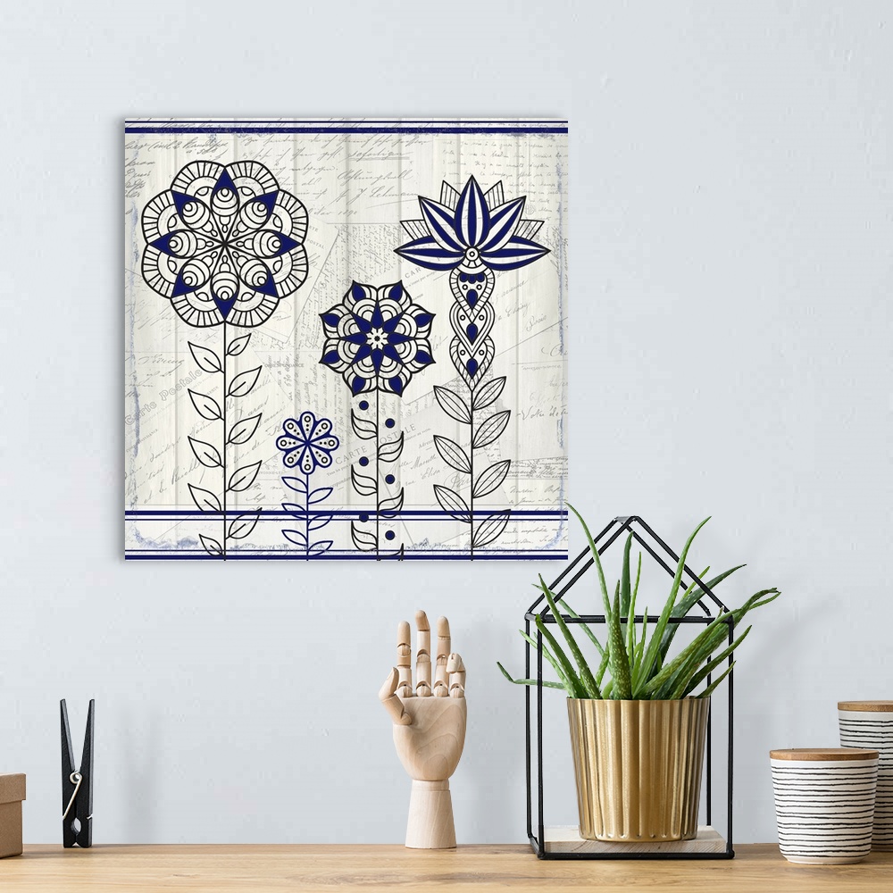 A bohemian room featuring A black and blue symmetric design of four flowers with a collage of handwritten postcards in the ...