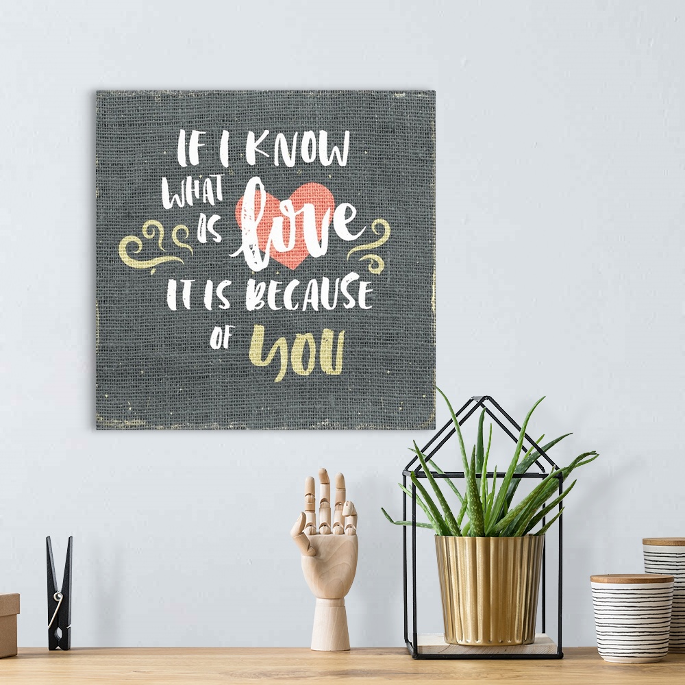 A bohemian room featuring "If I know what is love is it is because of you" written on burlap.