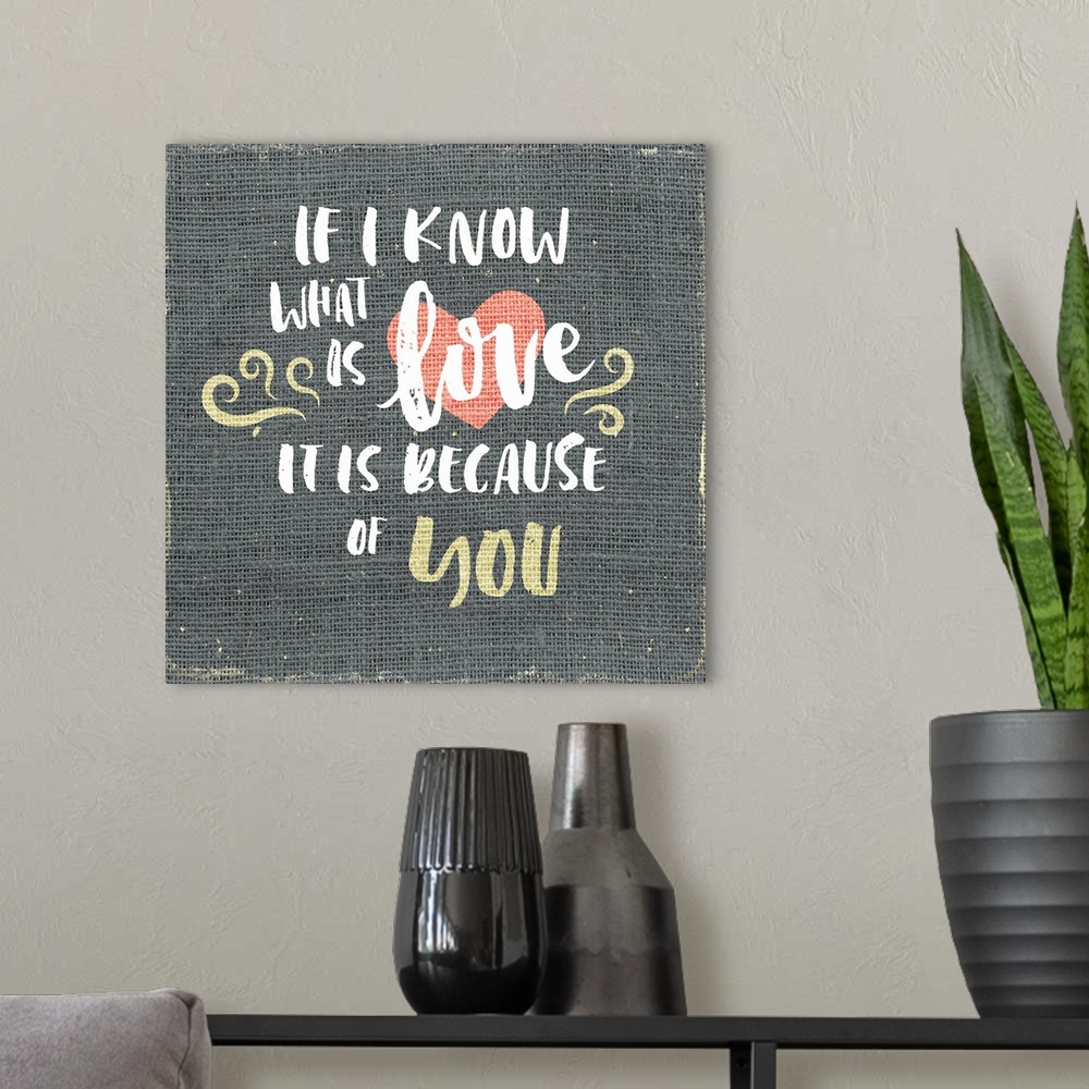 A modern room featuring "If I know what is love is it is because of you" written on burlap.