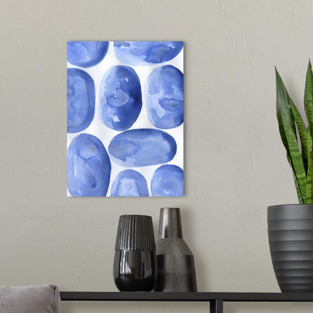 A modern room featuring Abstract artwork of round, blue shapes on white.