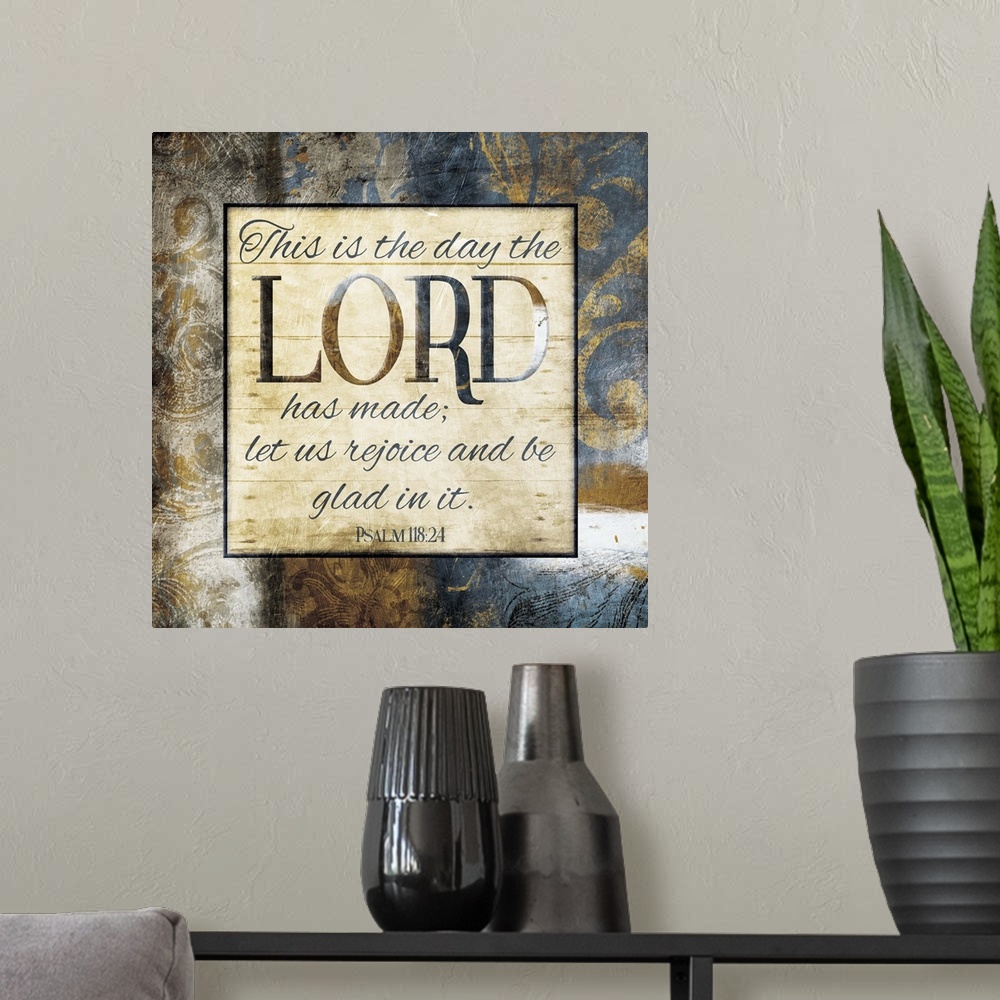 A modern room featuring Typography art of the Bible verse Psalm 118:24 framed with classic style gold and blue flourishes.