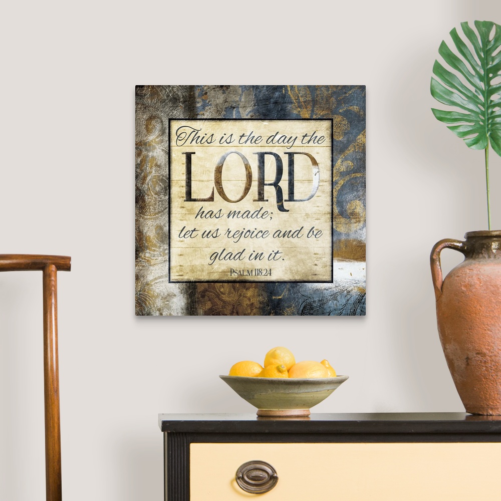 A traditional room featuring Typography art of the Bible verse Psalm 118:24 framed with classic style gold and blue flourishes.