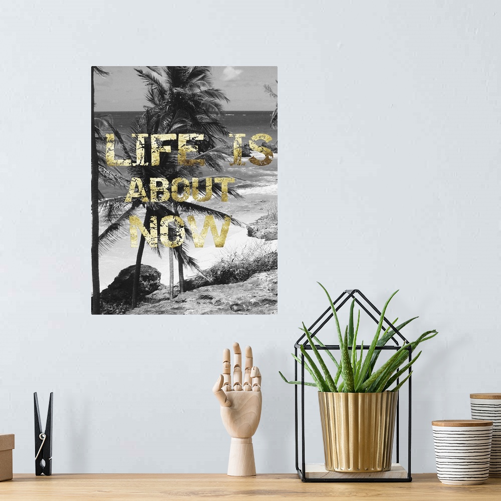 A bohemian room featuring "Life is about now" written on top of a black and white photo of a beach scene with palm trees.
