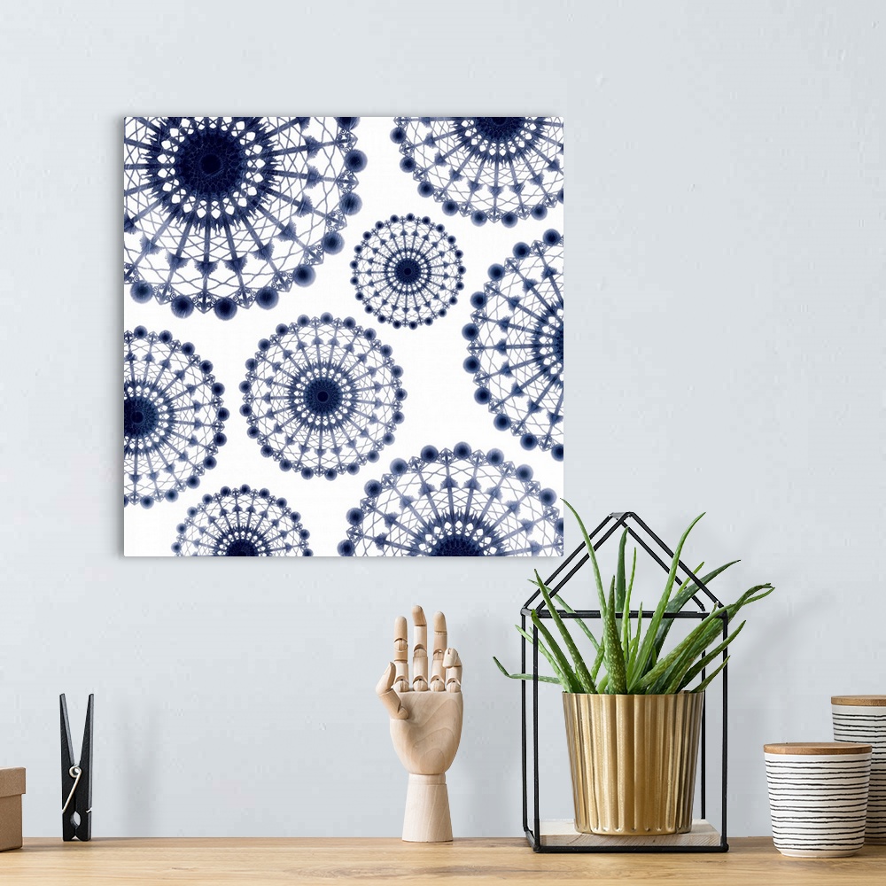 A bohemian room featuring Contemporary blue and white geometric artwork.