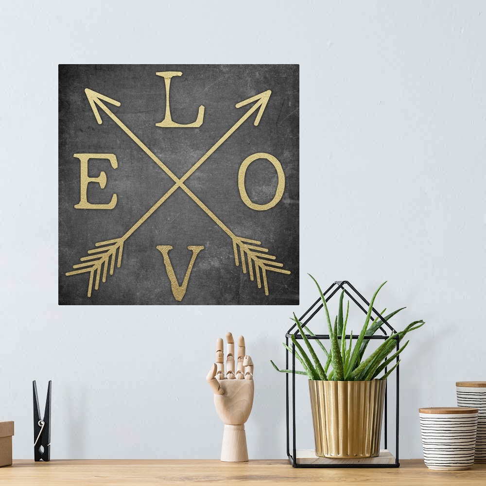A bohemian room featuring Contemporary home decor typography artwork of the word LOVE in gold against a black background.