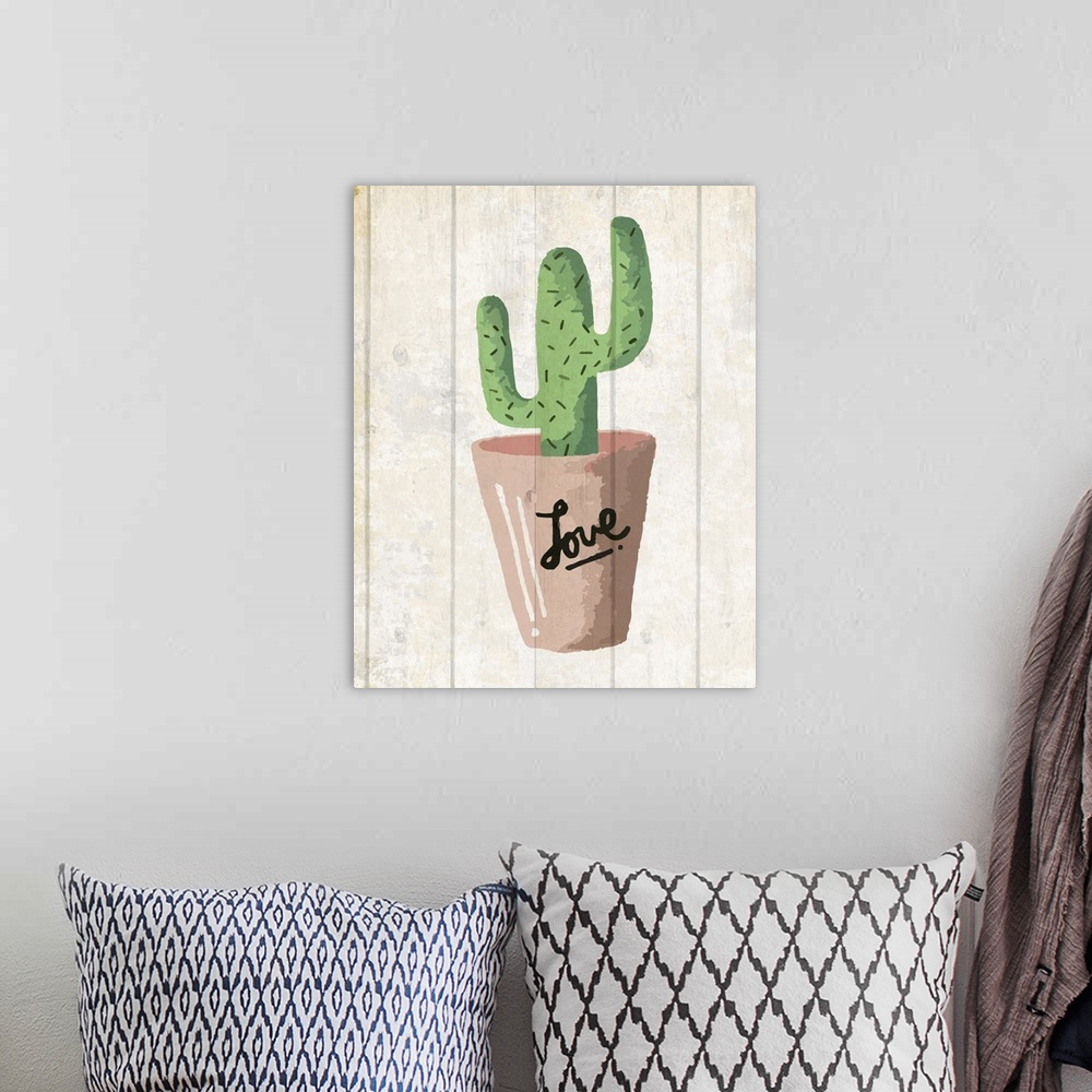 A bohemian room featuring A painting of a cactus in a clay pot with the word ?love? written on it placed on a wooden backgr...