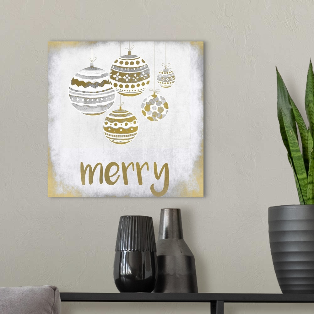 A modern room featuring Gold and silver holiday ornaments hanging over the word "Merry."