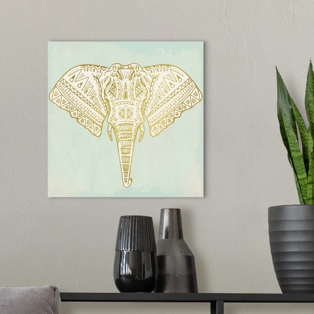 A modern room featuring Square art of a uniquely designed metallic gold elephant on a light blue-green painted background.