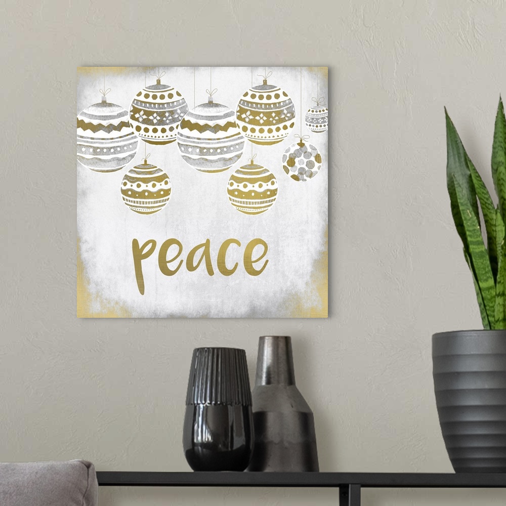 A modern room featuring Gold and silver holiday ornaments hanging over the word "Peace."