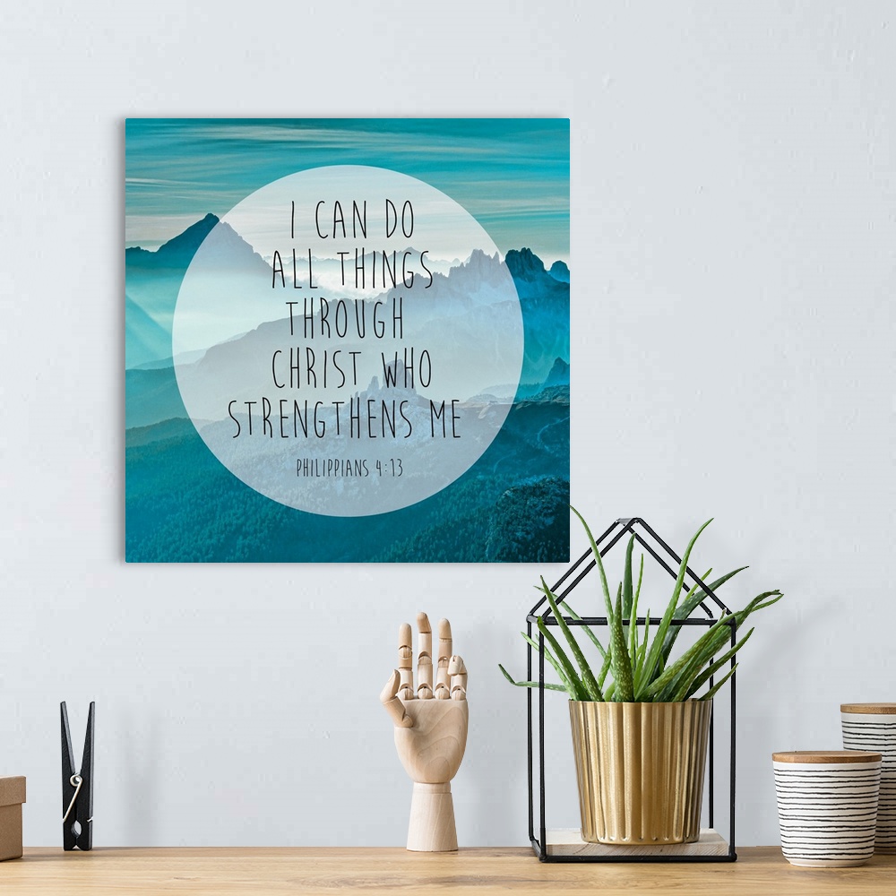 A bohemian room featuring Typography art of a Bible verse over an image of blue, misty mountains.